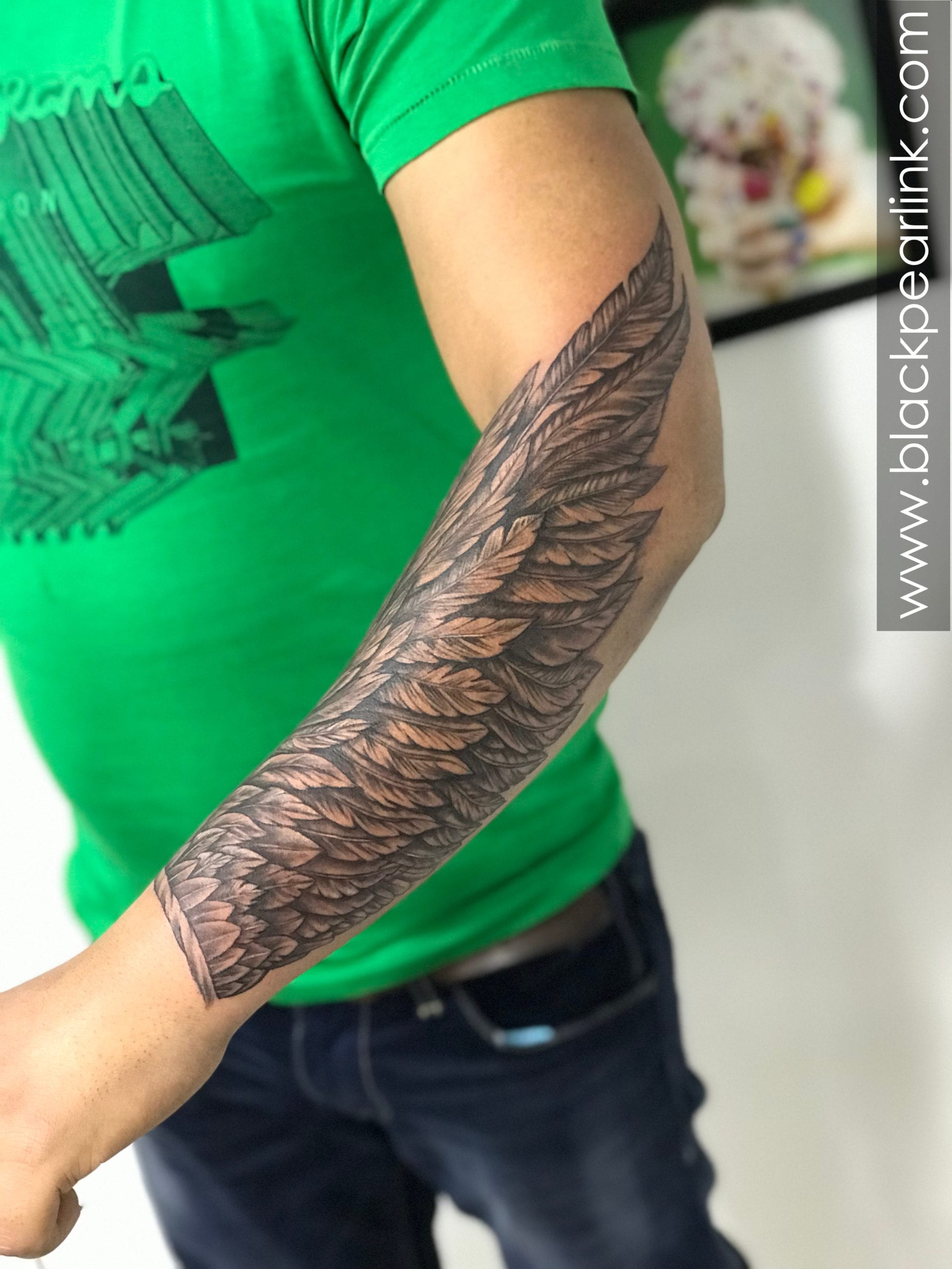 Forearm tattoo of a wing.